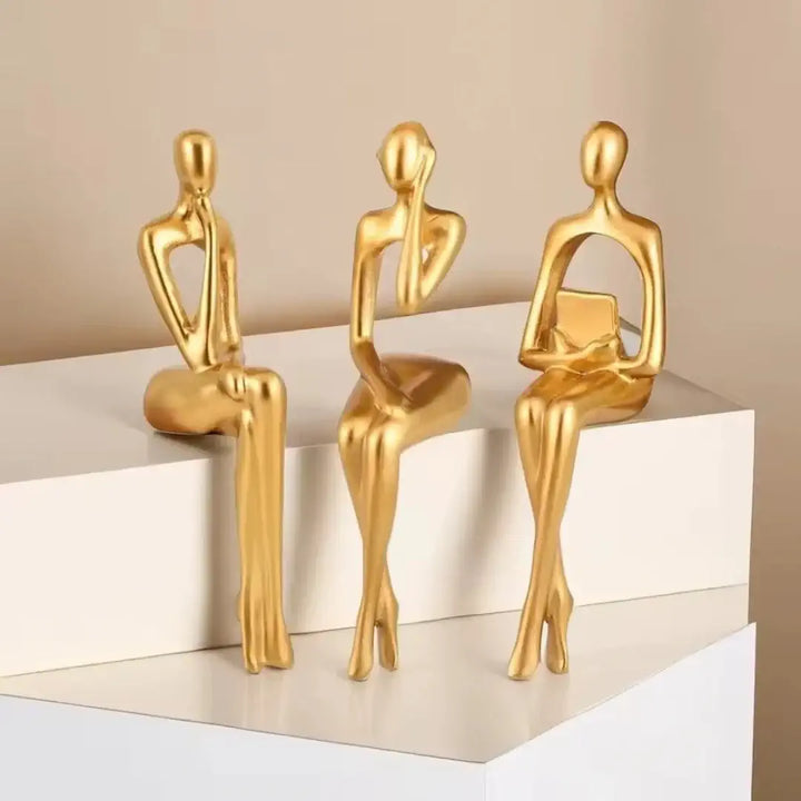 Estatuetas Leitor Sentado Casavelle decorando escritório, representando liderança, conhecimento e prestígio.